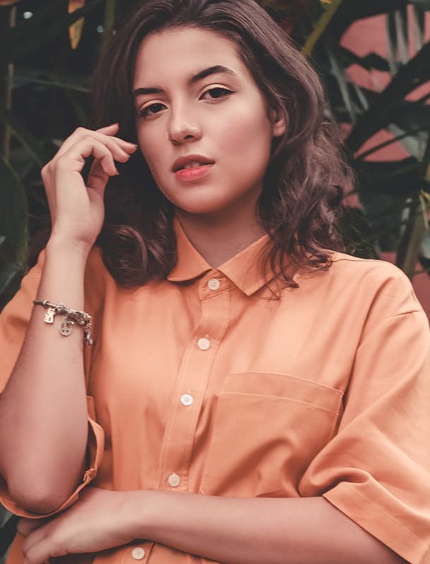 Model wearing peach button-up shirt from Base Apparel